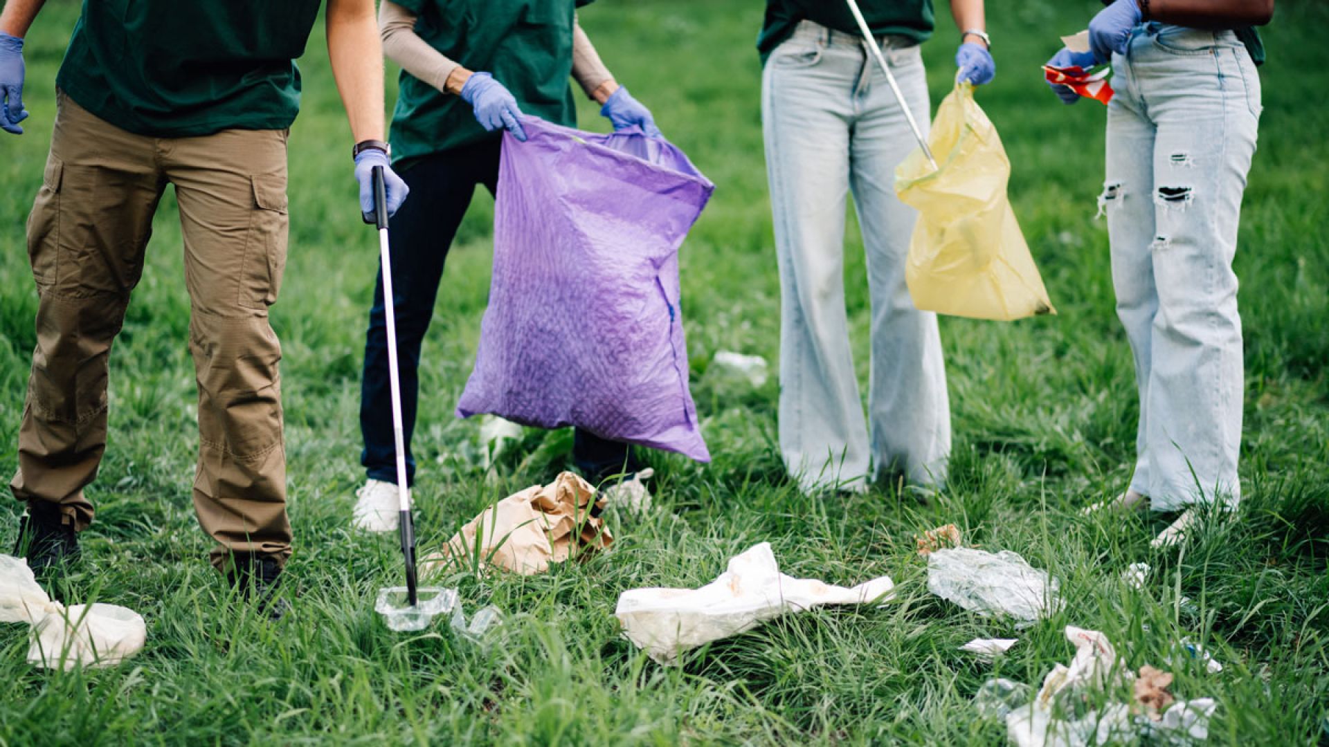 group of volunteers cleaning up trash outside