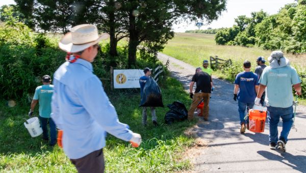 lightwave solar team cleaning up trash outside