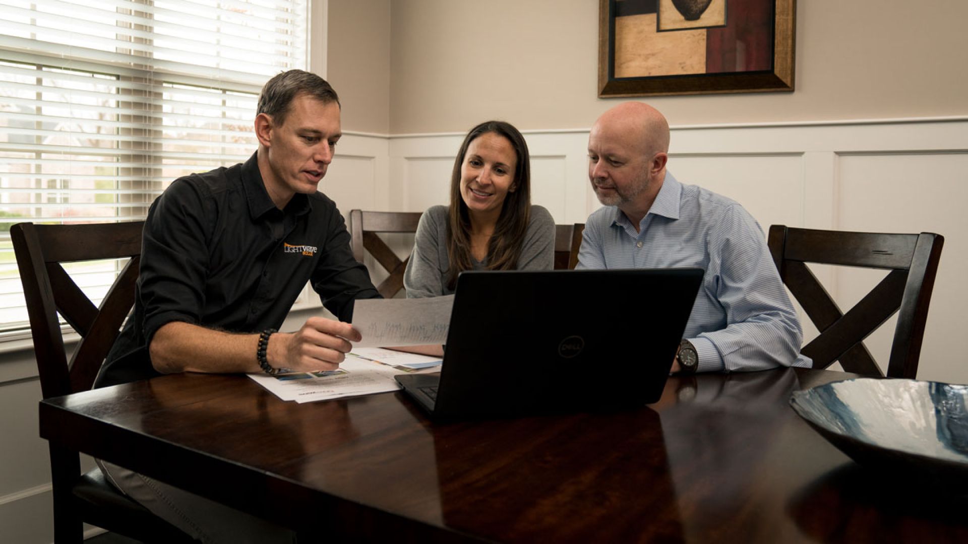 Lightwave consultant going over solar proposal with clients
