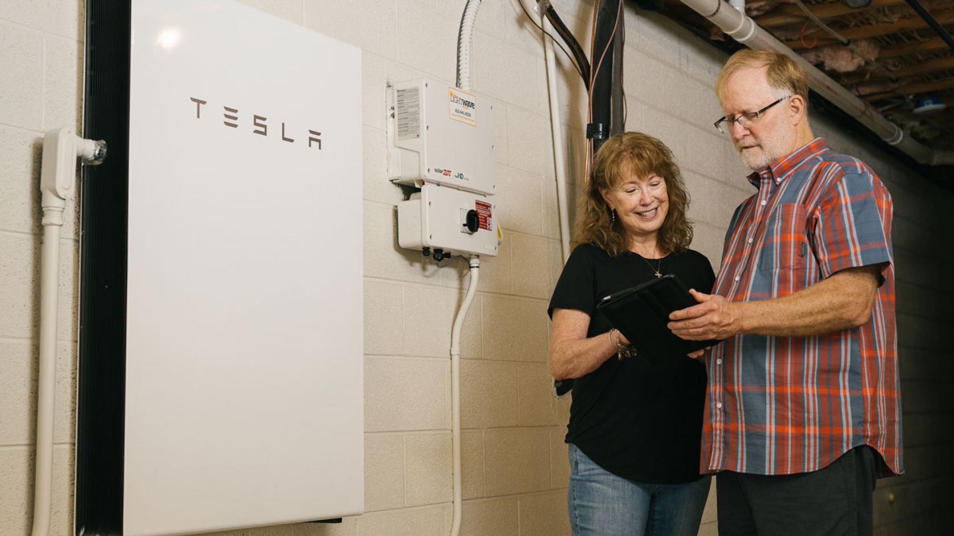 couple in Tennessee in garage with Tesla Powerwall battery