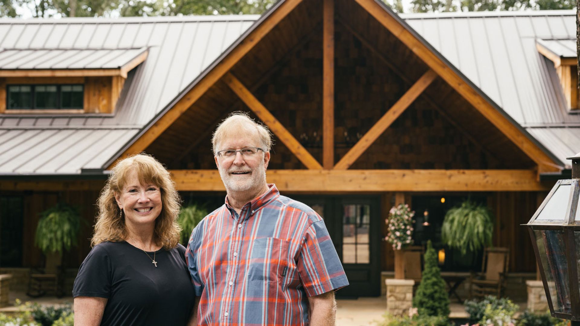 happy couple standing in front of home